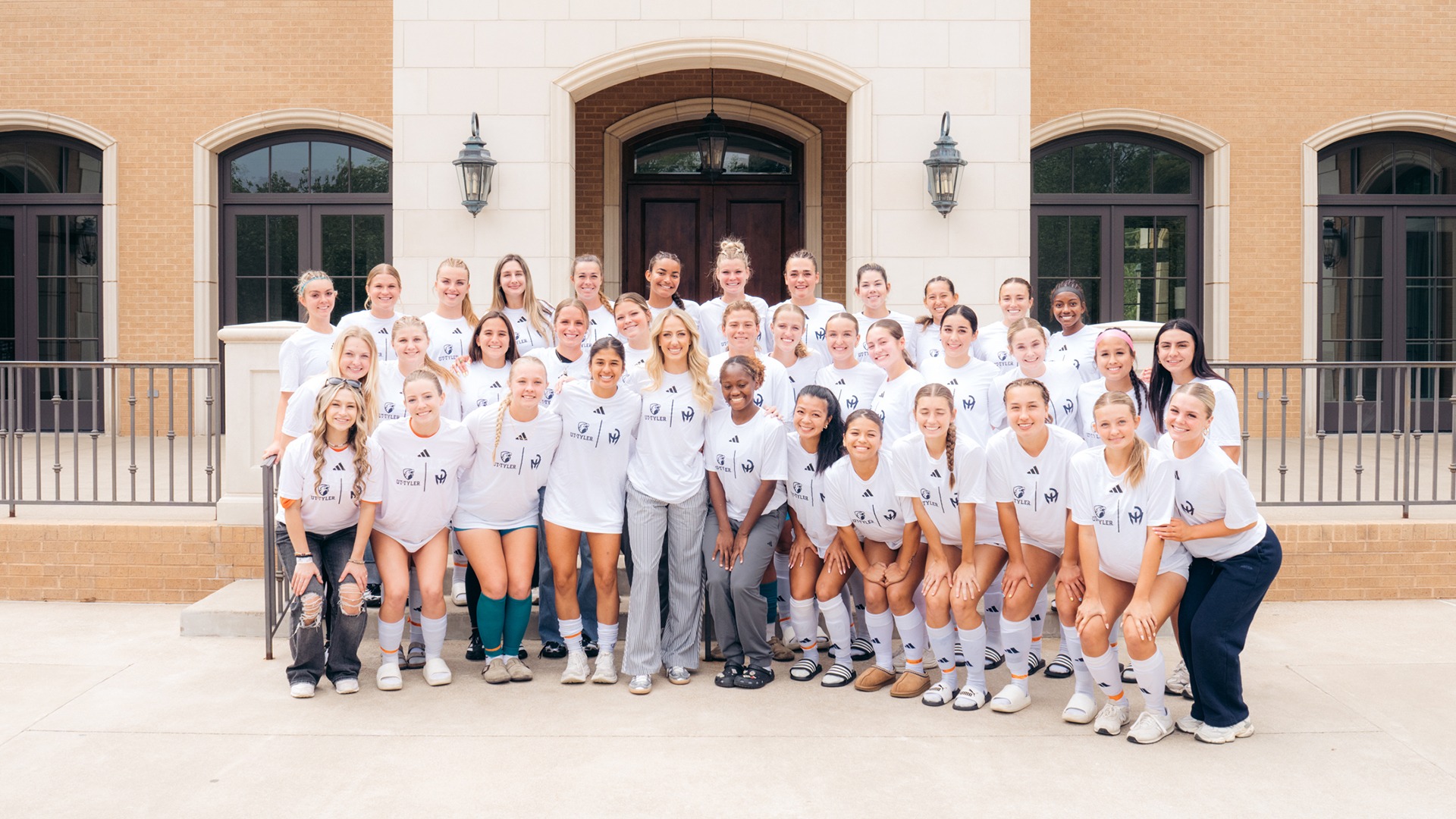 Brittany Mahomes and UT Tyler Women's Soccer pose for a picture in their new Team Mahomes shirts.