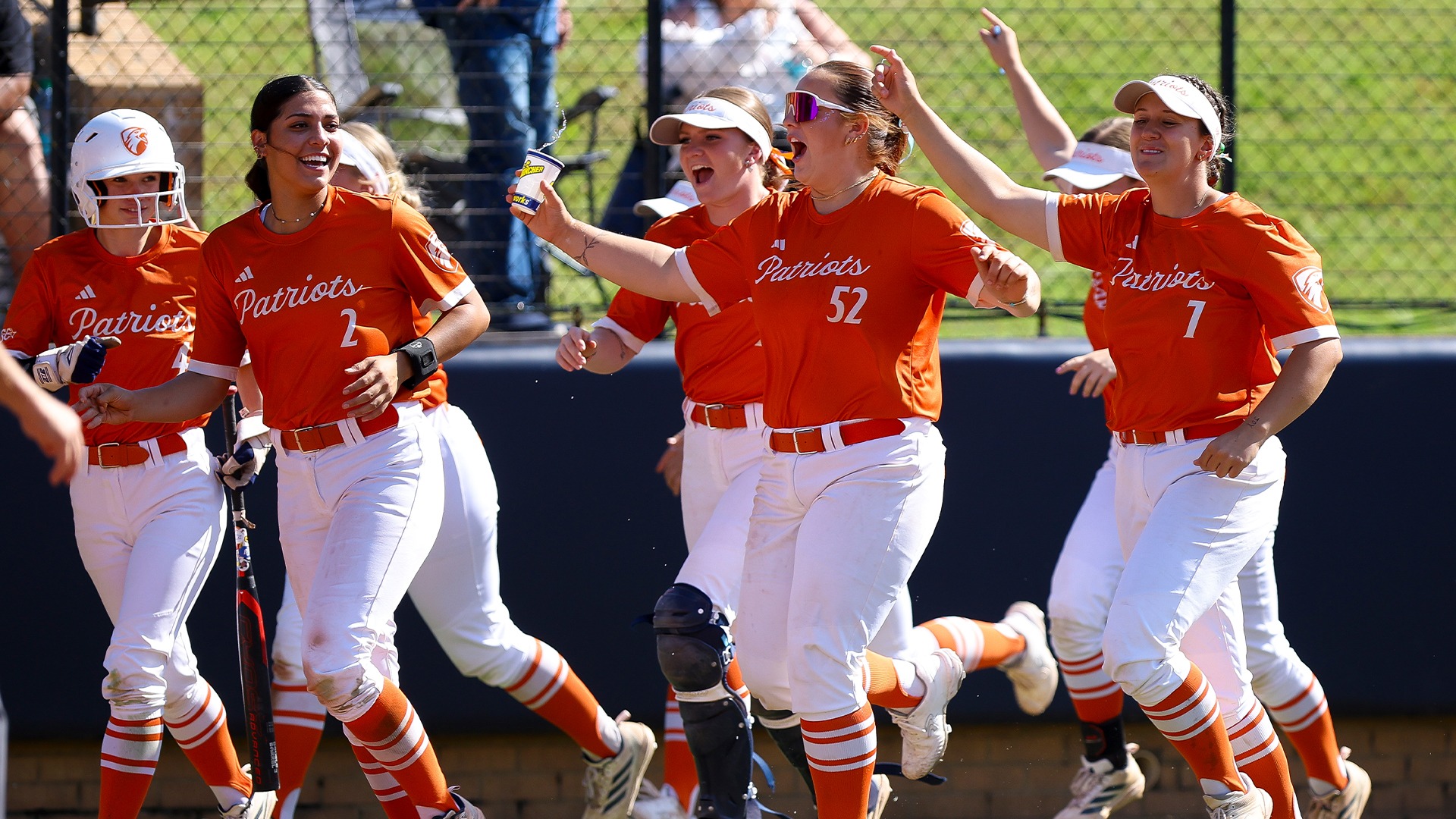 UT Tyler's dugout runs to the plate to celebrate a home run.