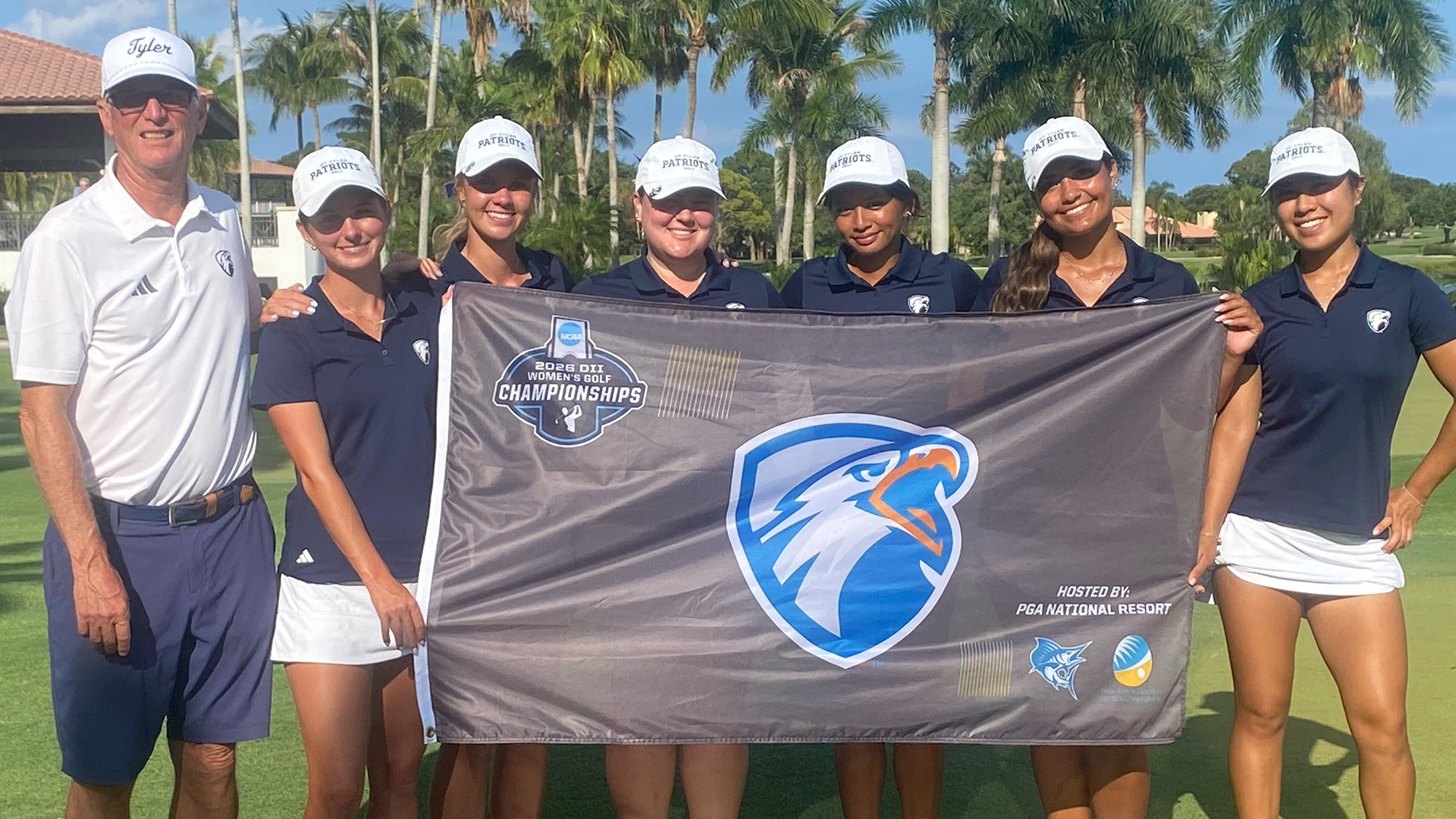 UT Tyler women's golf poses with their flag at the NCAA Championship.