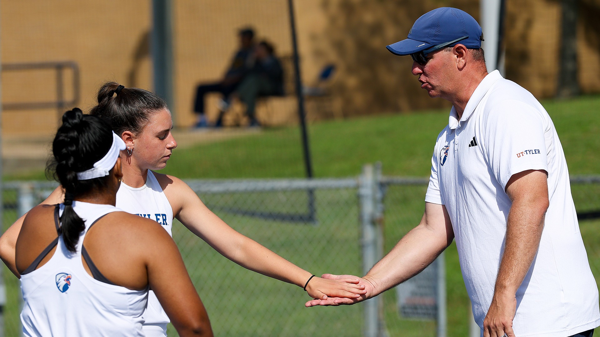 Head Coach Chris Bizot high fives Paula Castellanos and Maria Antonio Ortega against Cameron.