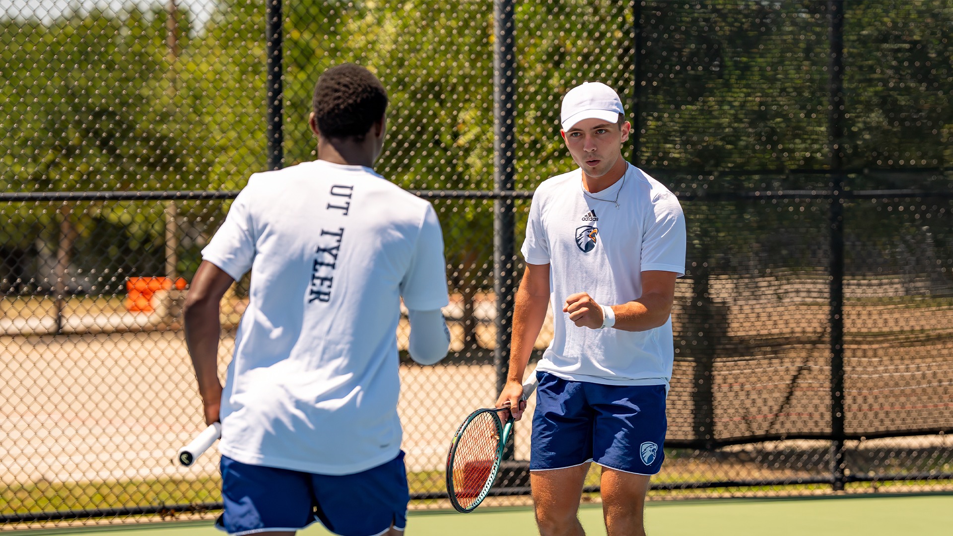 Samuel Antwi and Trevor Short share a celebration after a point in doubles against Lubbock Christian