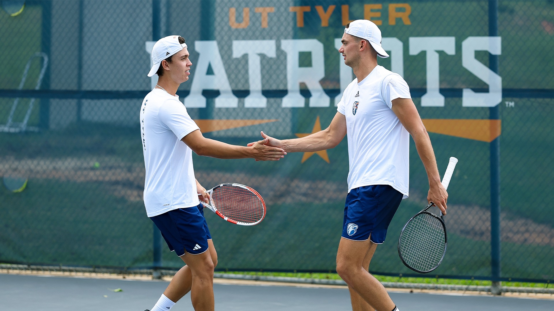 Daniil Felker and Carel Wessel slap hands after a doubles point against St. Mary's.