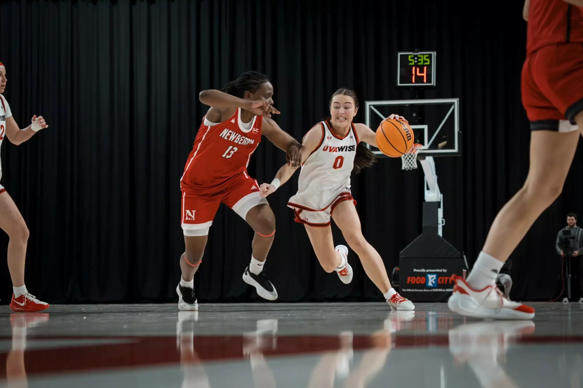 Mia Nienaber drives past Newberry's Daria Clet -- 2025-26