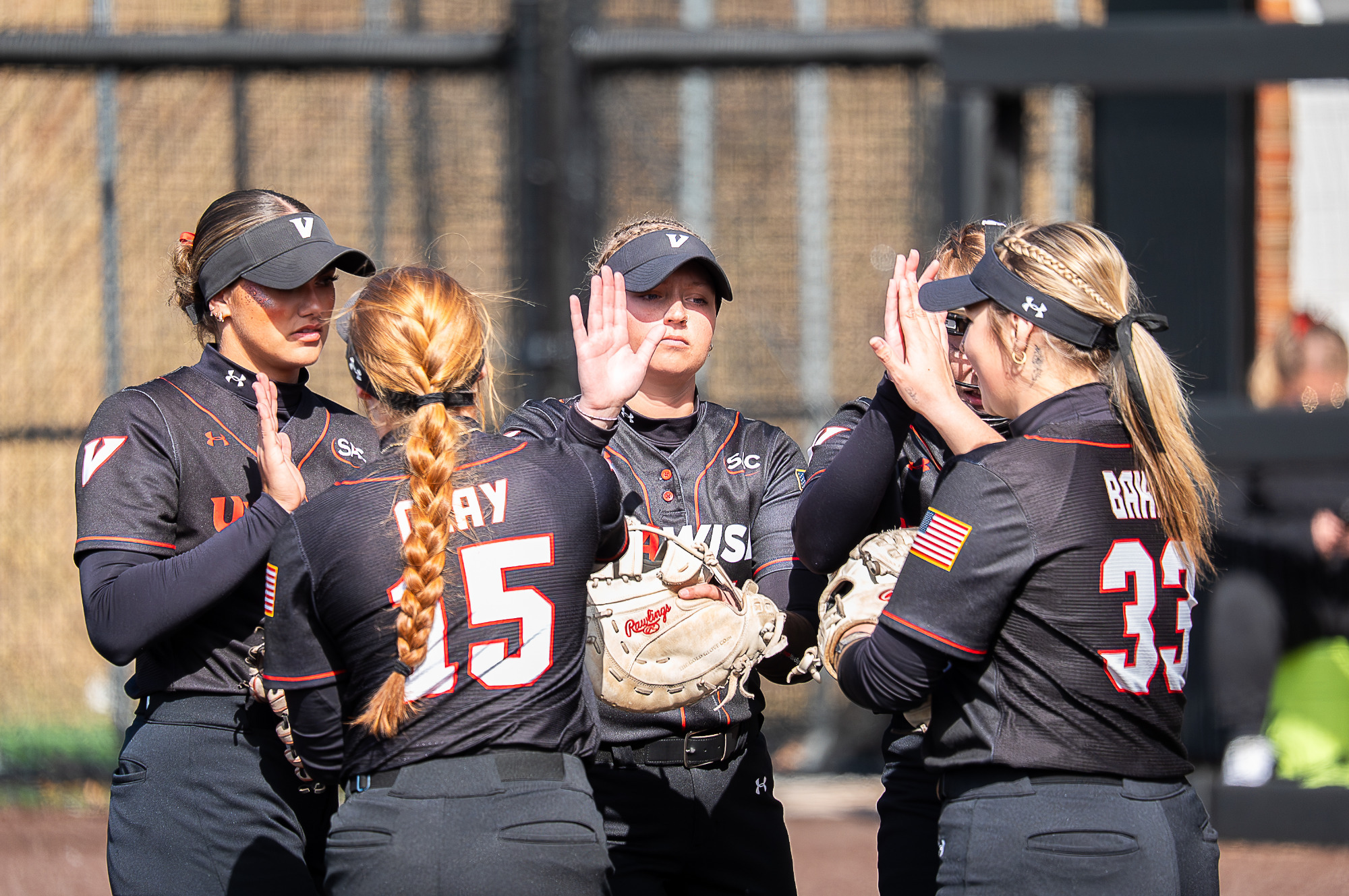 Softball players high five each other vs Virginia State -- 2026