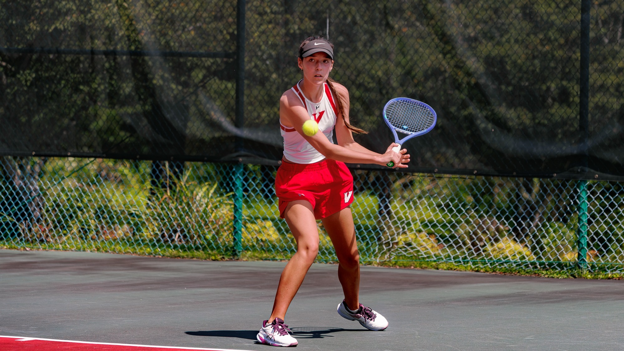 Women's Tennis player hits the ball in fall practice 2026
