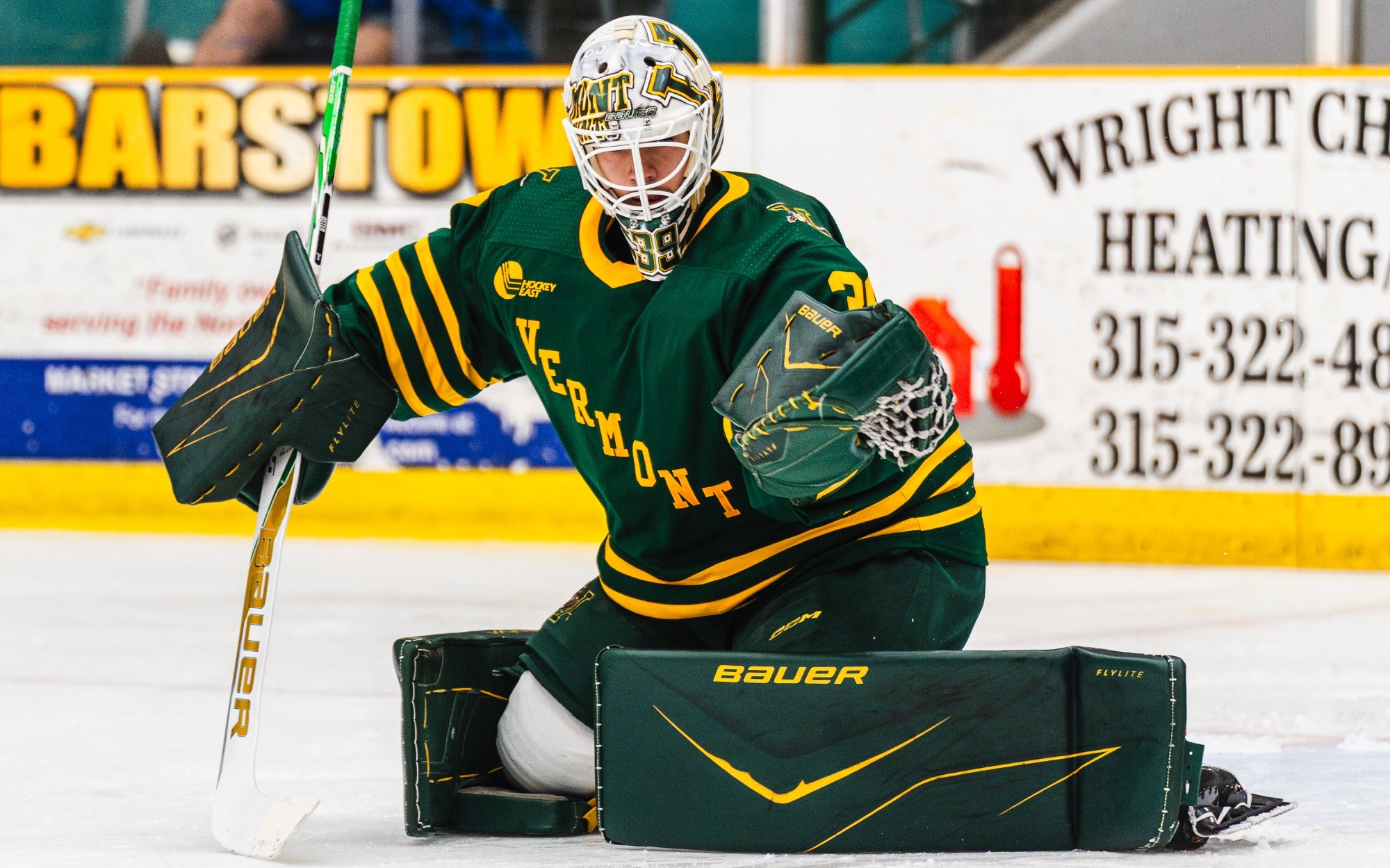 Jacob Oster makes a glove save during warmups at Clarkson