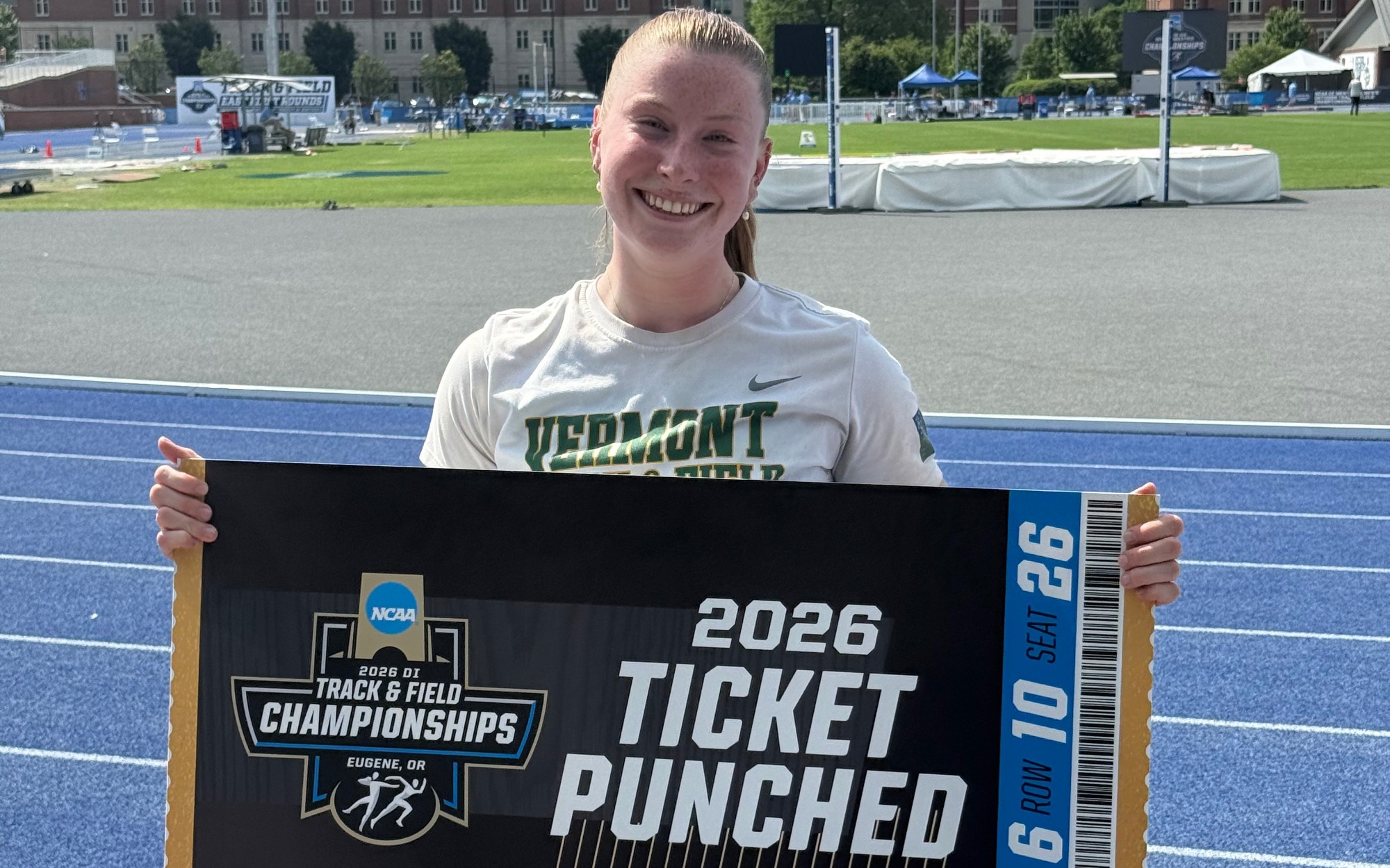 Senior Emma Wapshare holds the Ticket Punched sign for Vermont after qualifying for the NCAA Championships