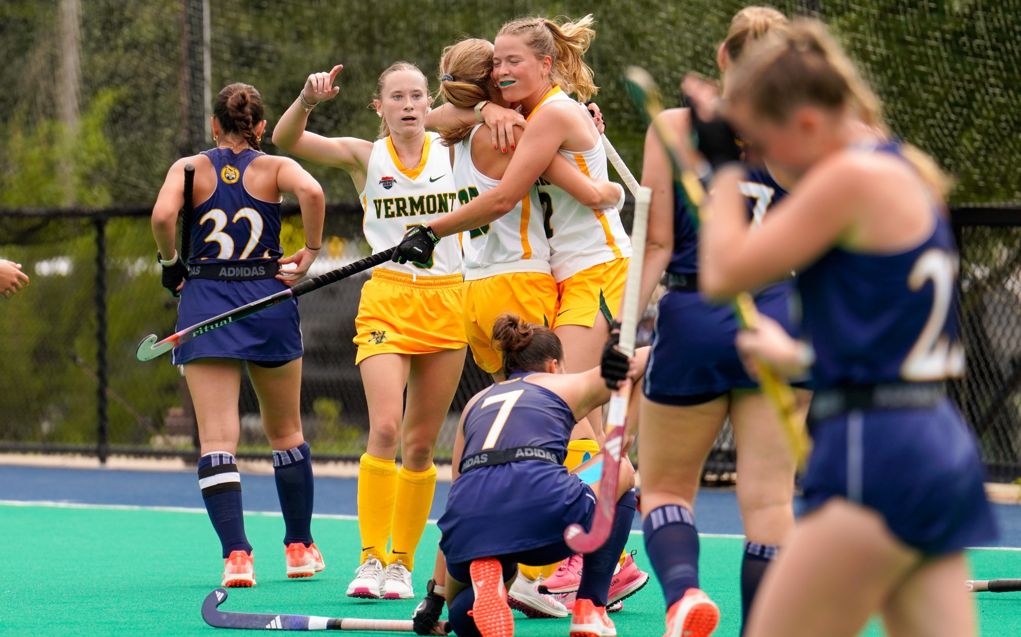 Catamounts celebrate their third goal of the game in front of the Quinnipiac net.