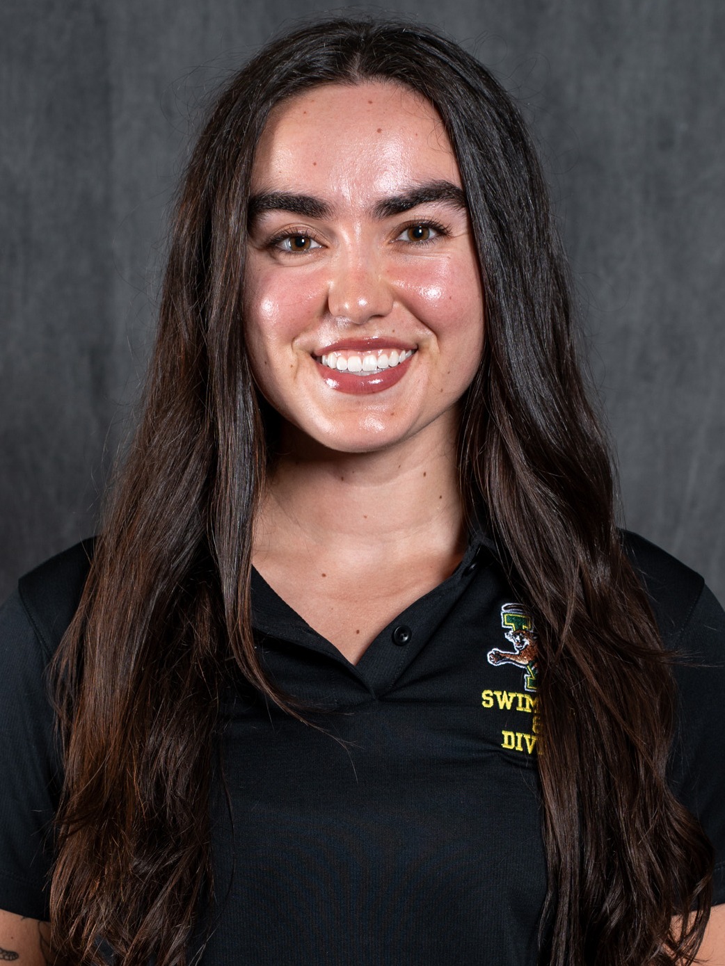 Headshot of Andrea Bellart in black UVM Swim and Dive polo