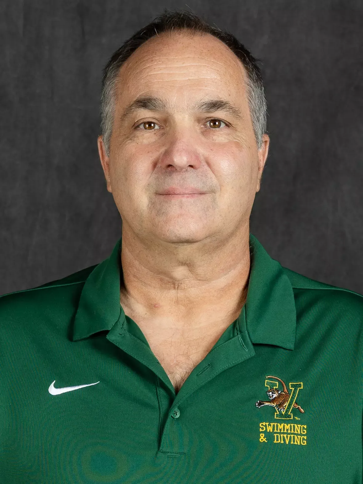 2026 Headshot on Grey Backdrop with Green Zip Up