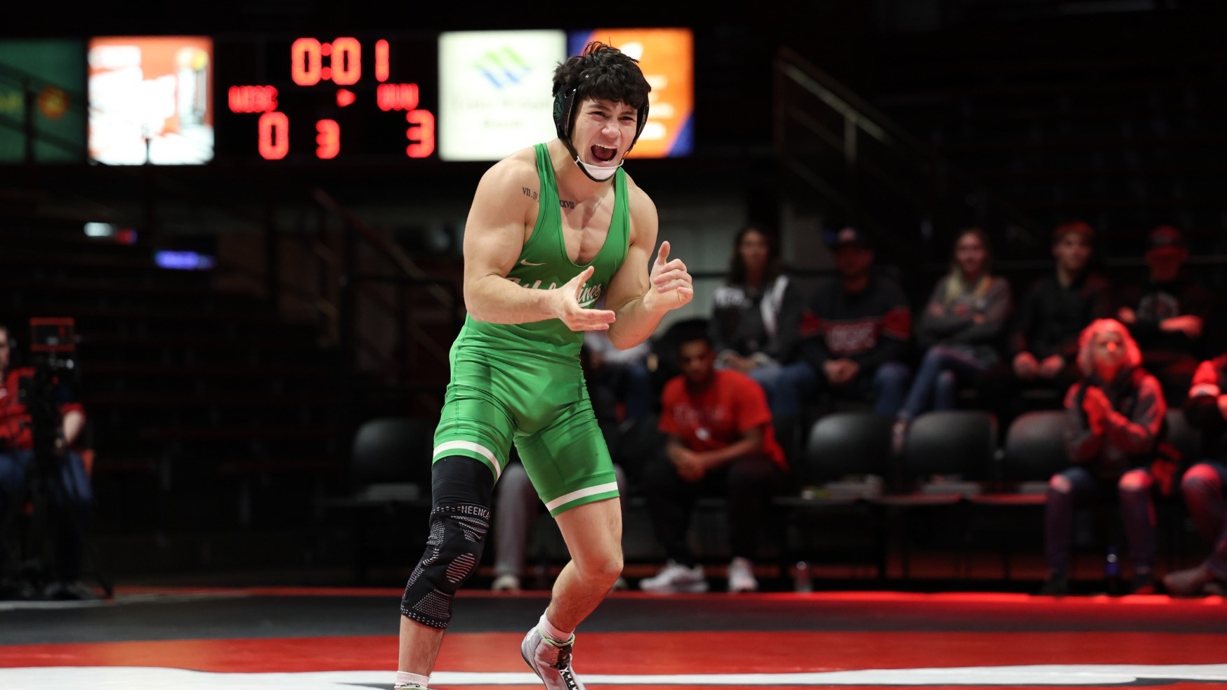 Geronimo Rivera celebrates after his upset of No. 7 Zan Fugitt of Wisconsin at 133 pounds