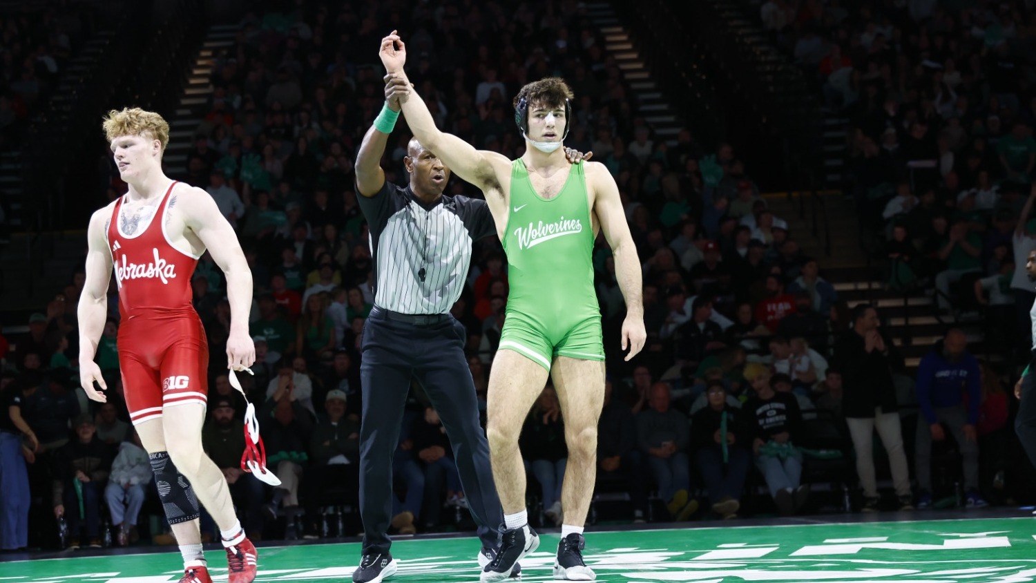 Caleb Uhlenhopp gets his hand raised after defeating Nebraska's Tyler Eise