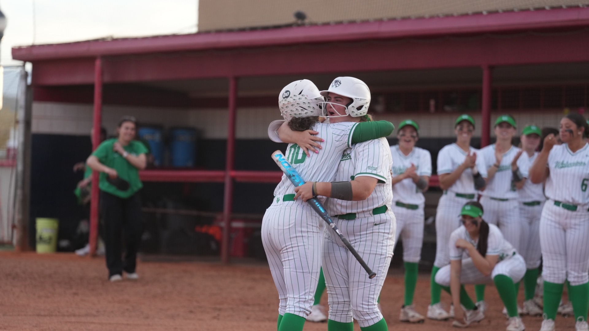 Angelique Mann hugs Emma Haygood after hitting a homer vs Weber State.