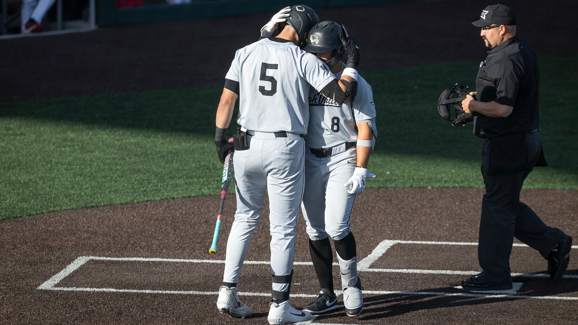 Chipper Beck and Kaden Carpenter celebrate at homer at Utah