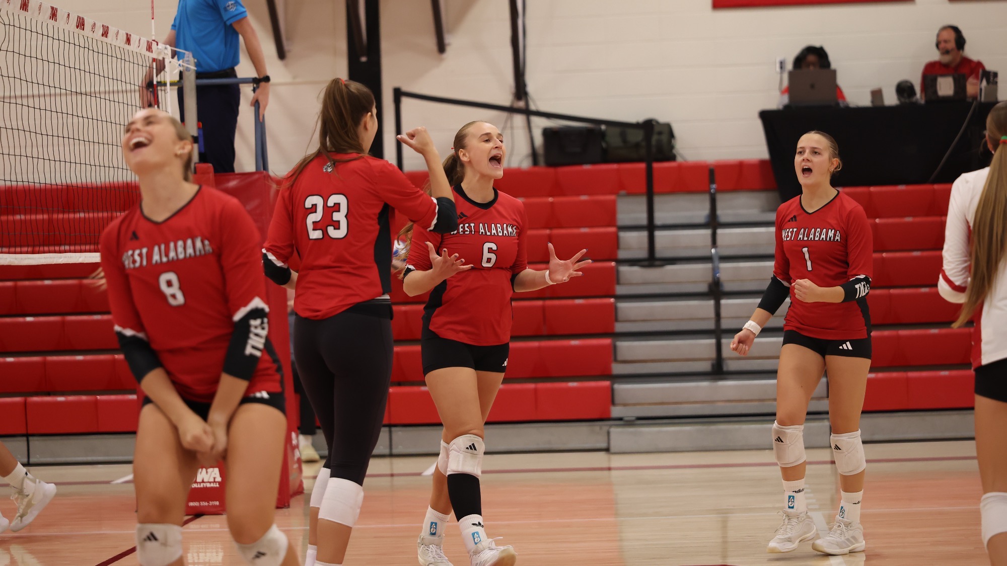 West Alabama volleyball players celebrate on the court during the Tigers’ match against Auburn University at Montgomery inside Pruitt Hall.