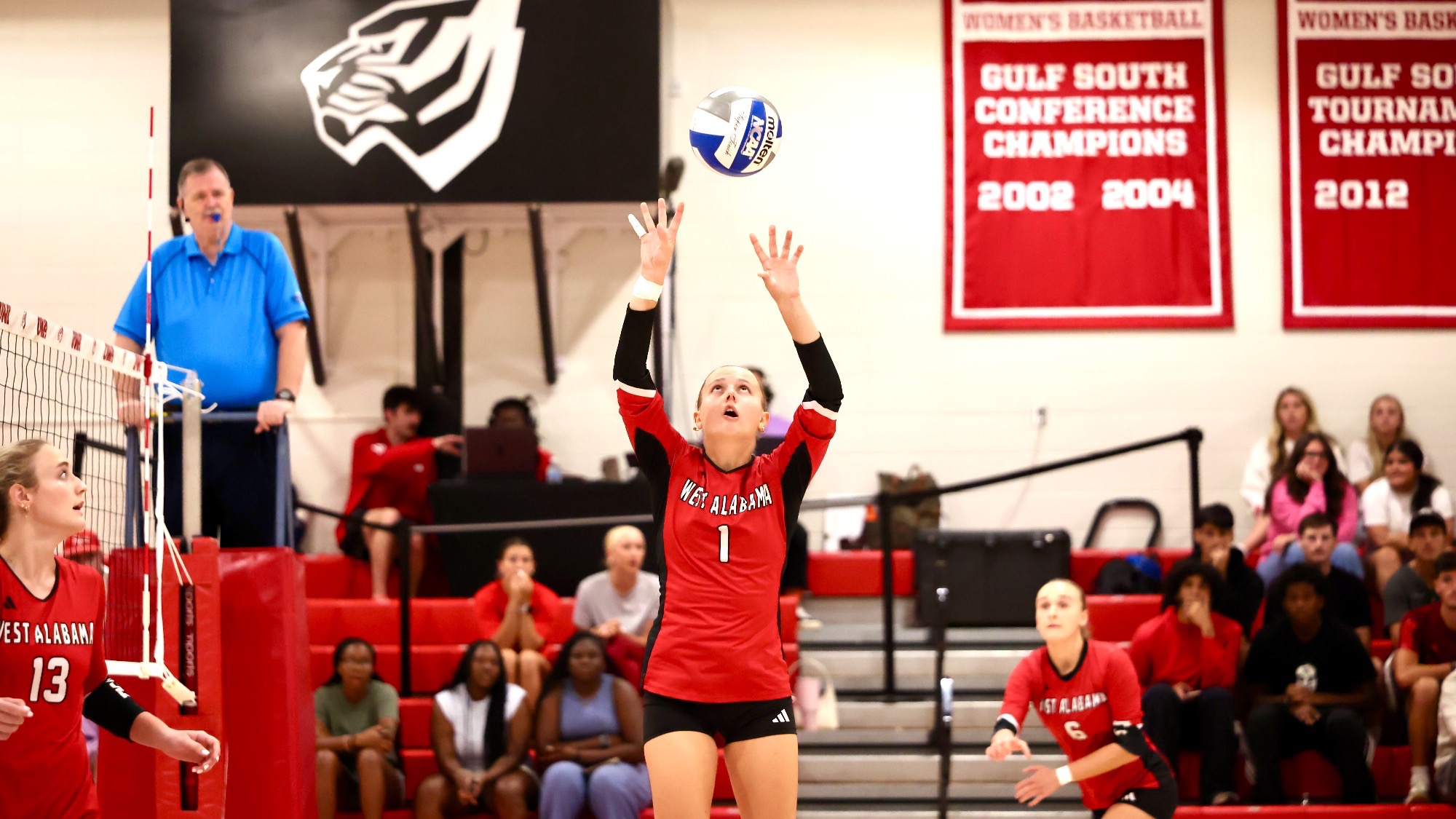 West Alabama setter Rachele Zanini (1) sets the volleyball above her head during a match inside Pruitt Hall, with teammates positioned around her.