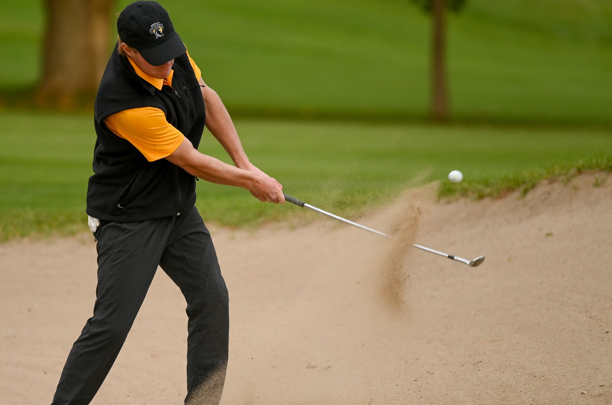 Men's golf shot from bunker