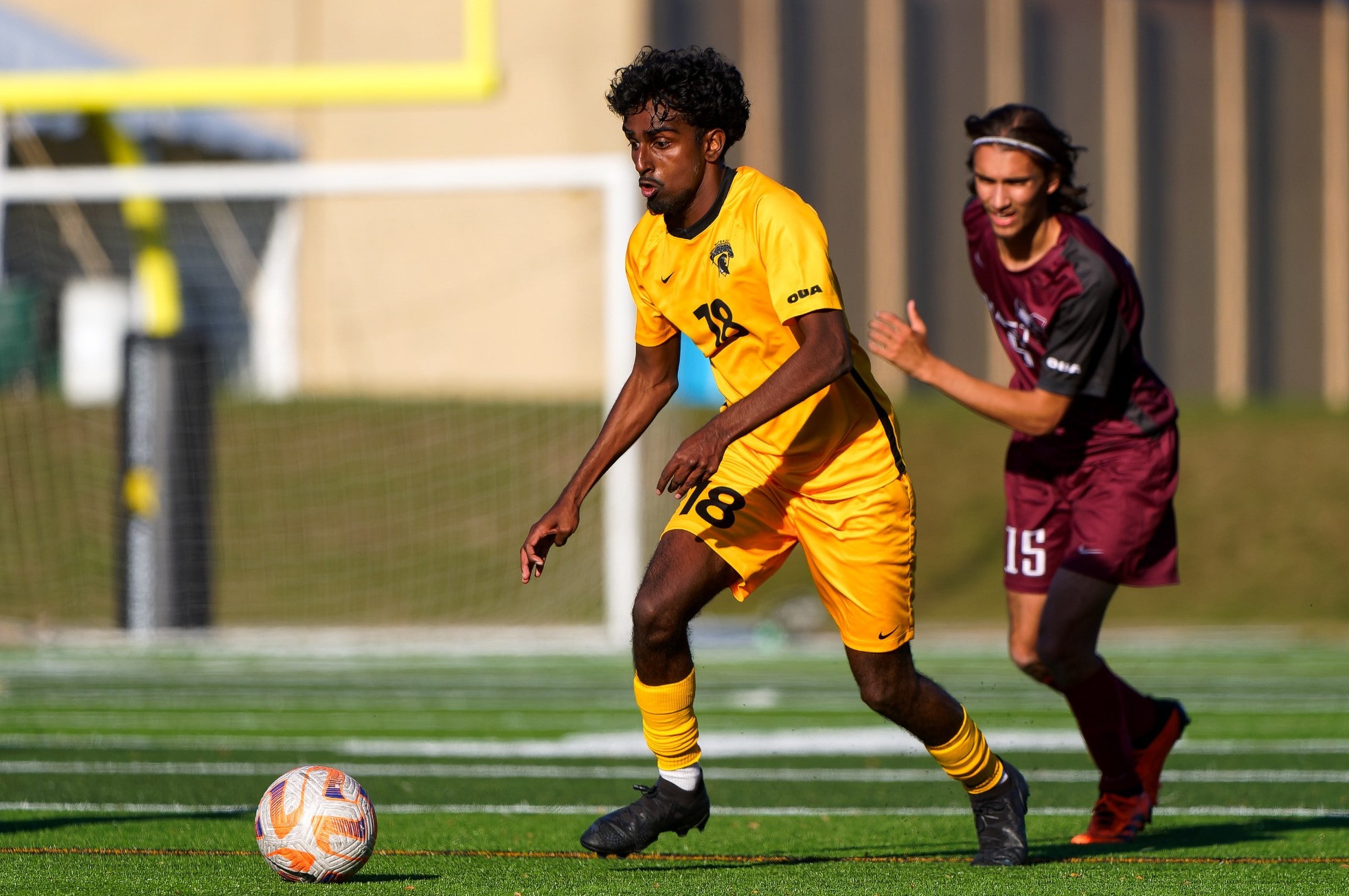 Warrior dribbling the ball up the field.