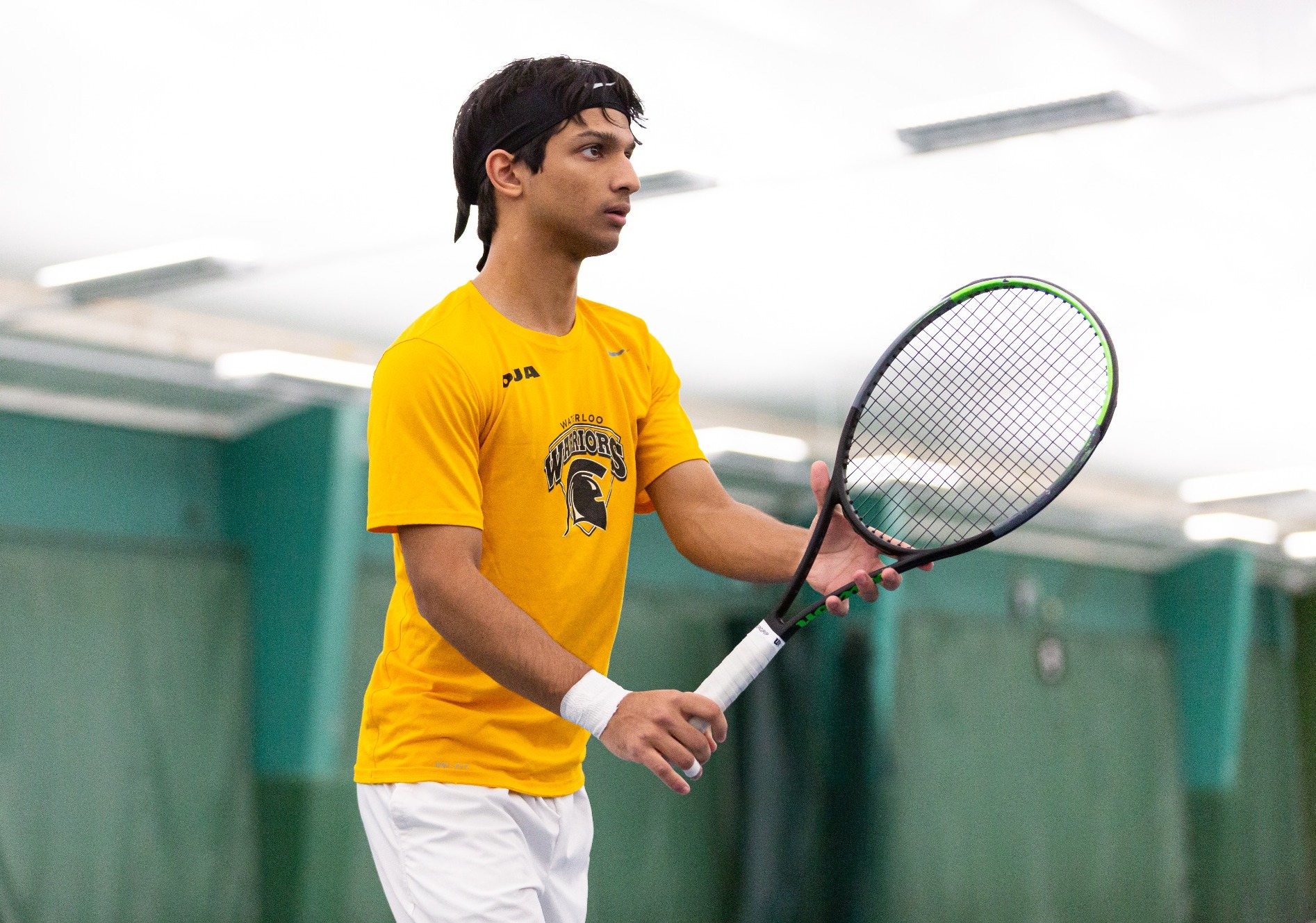 Tennis player standing ready.