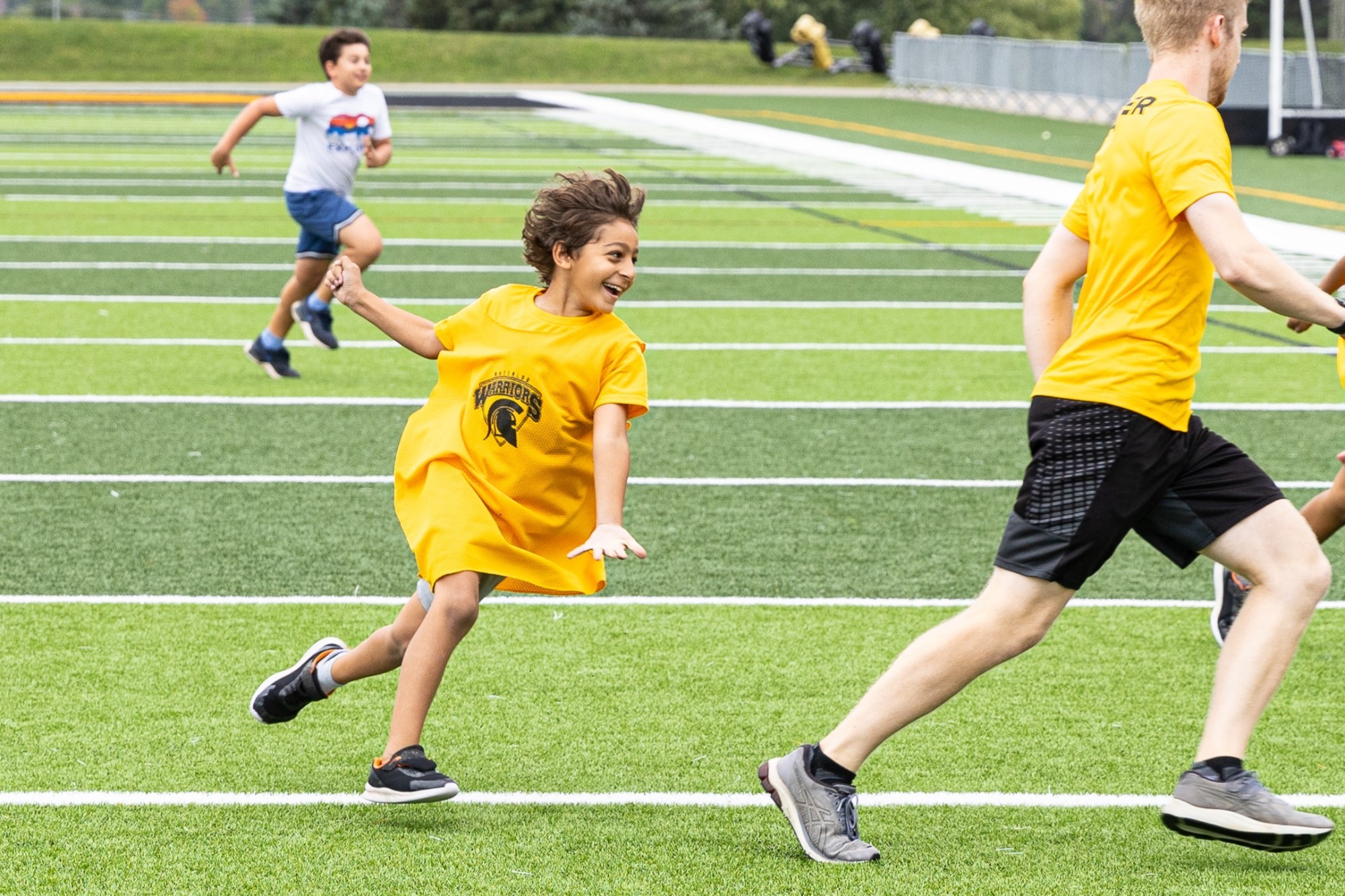 Warriors Multi-Sport Camper running after counsellor