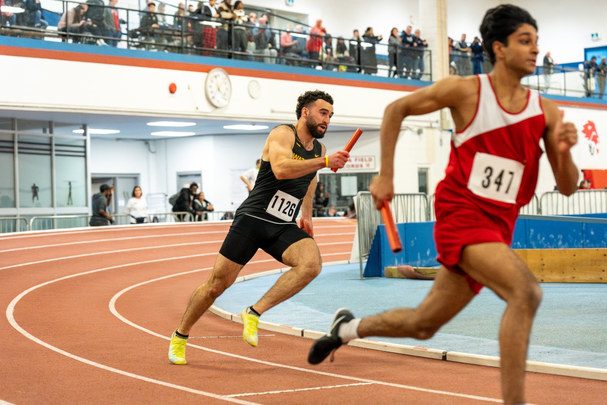 Waterloo Warriors track & field athlete running track with ballot in hand 