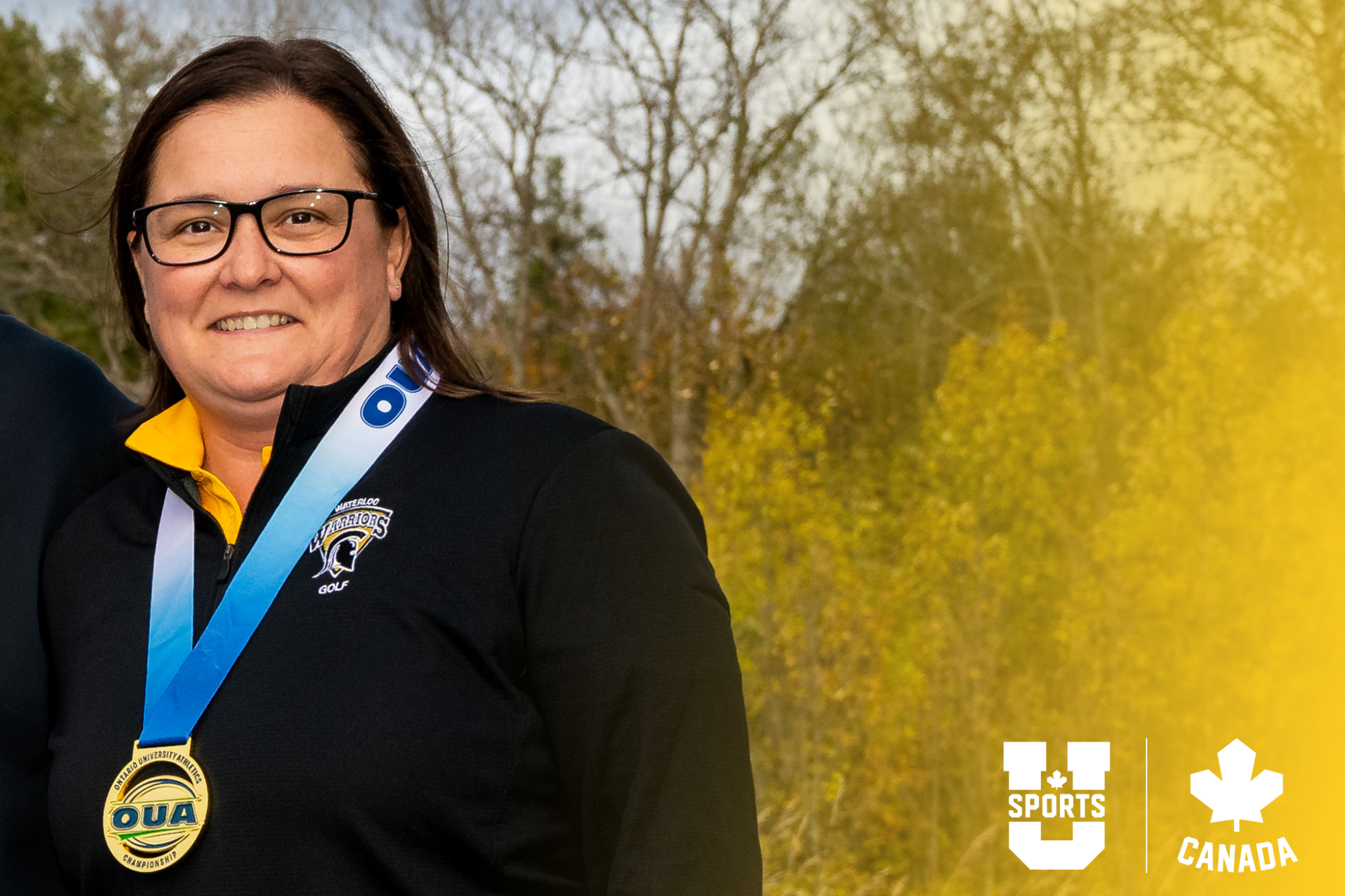 Tara Savioe, men's golf head coach smiling at the camera