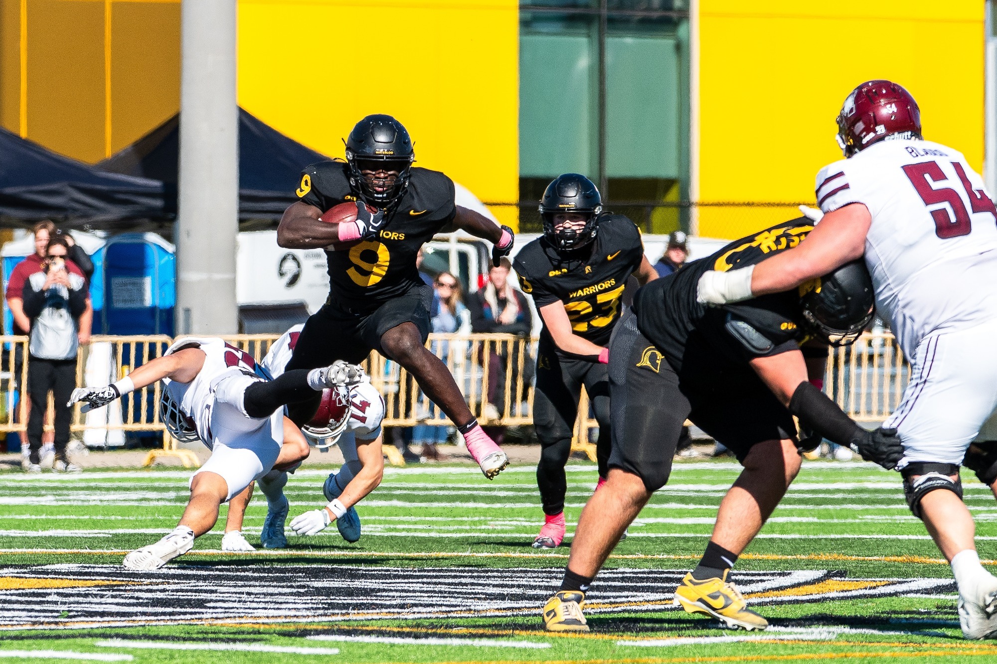 Michael Omoseni returns an interception vs McMaster