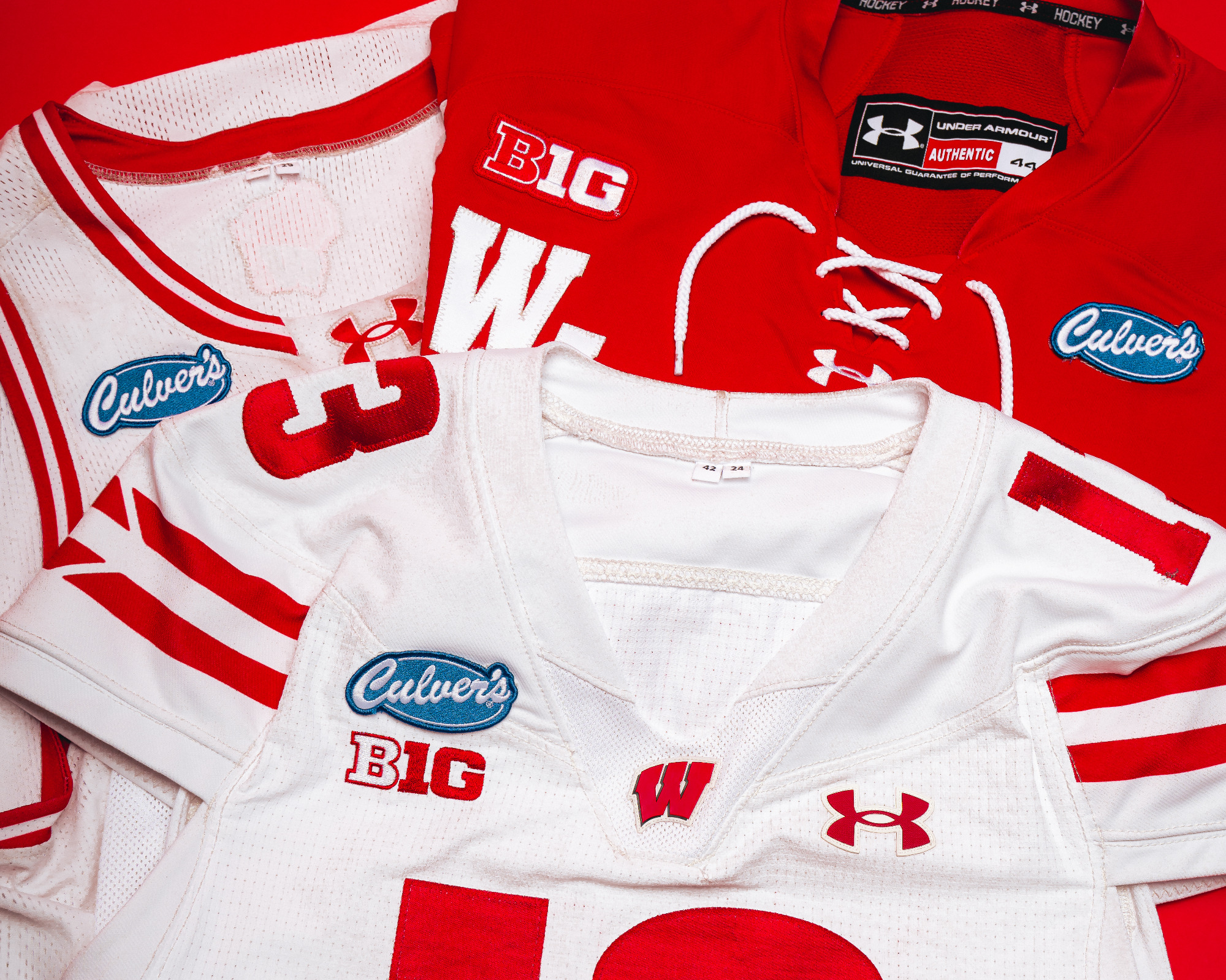 Three Wisconsin jerseys laying flat with Culver's patches