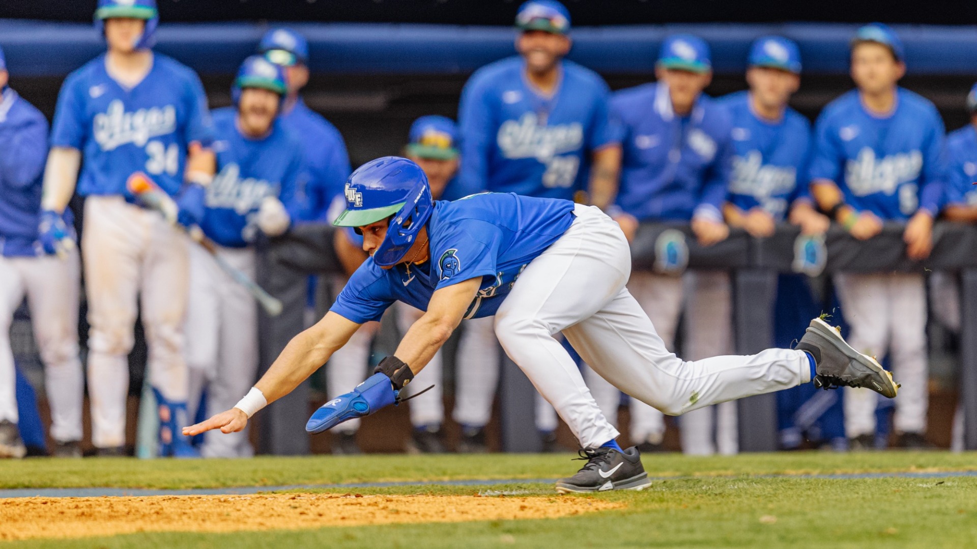 Baseball player sliding into home