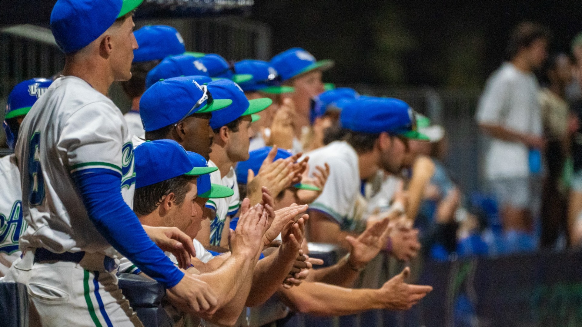Baseball players on the bench clapping