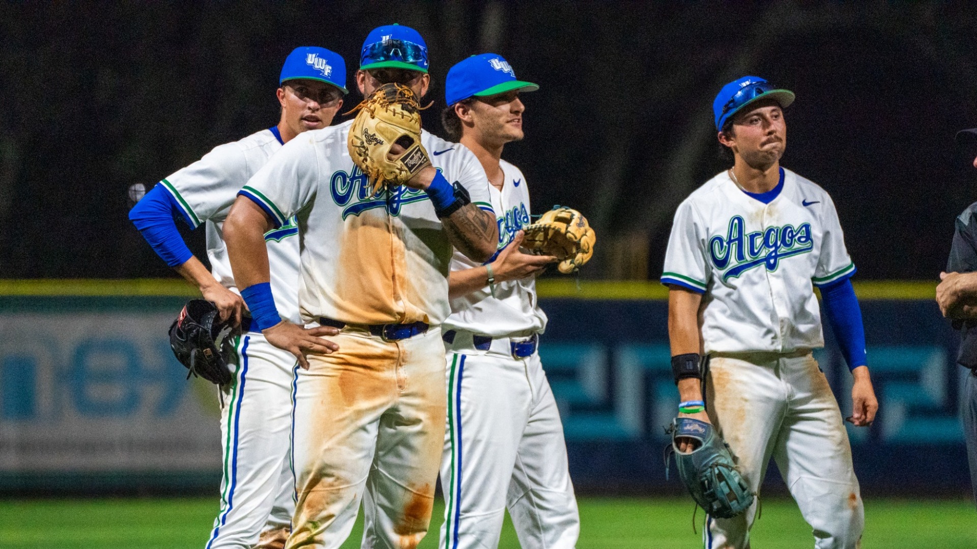Infielders huddled around the field