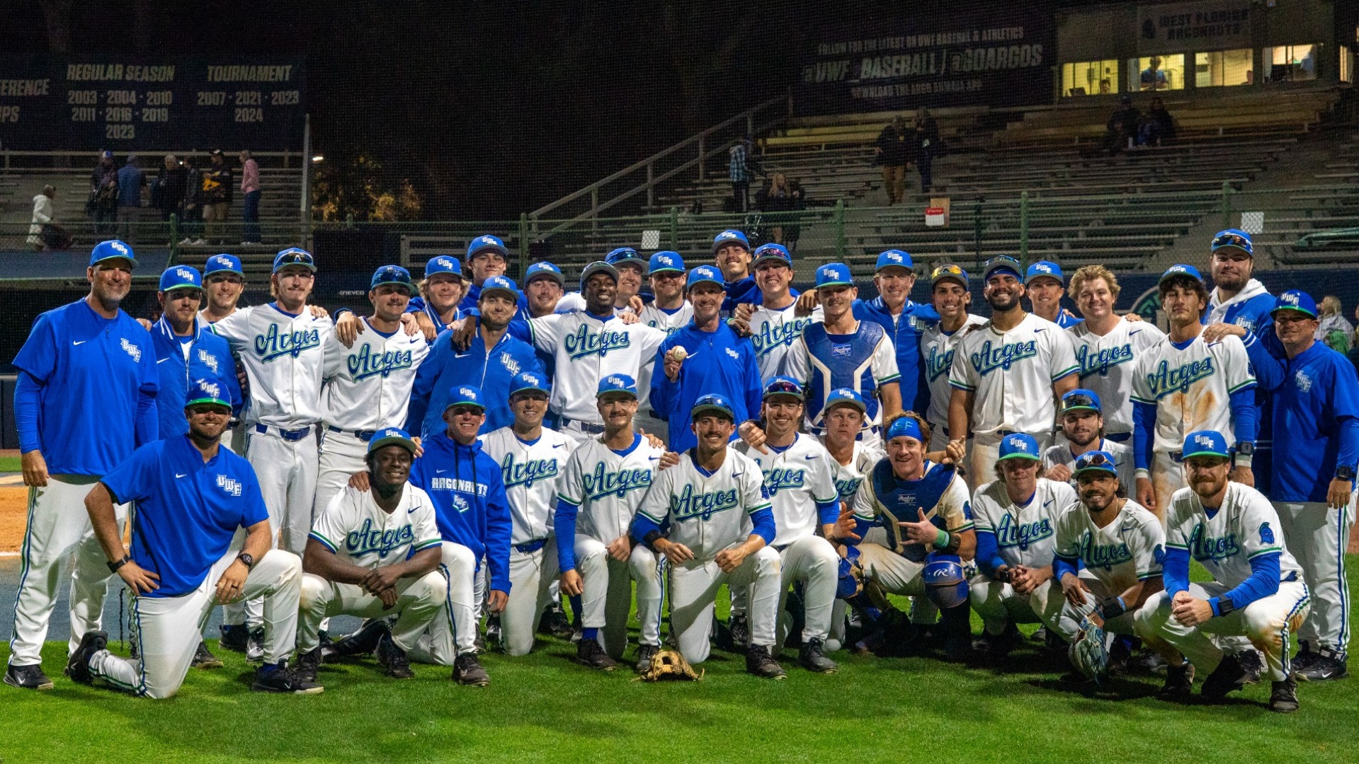 Baseball team poses with Coach Jeffcoat after his record breaking win