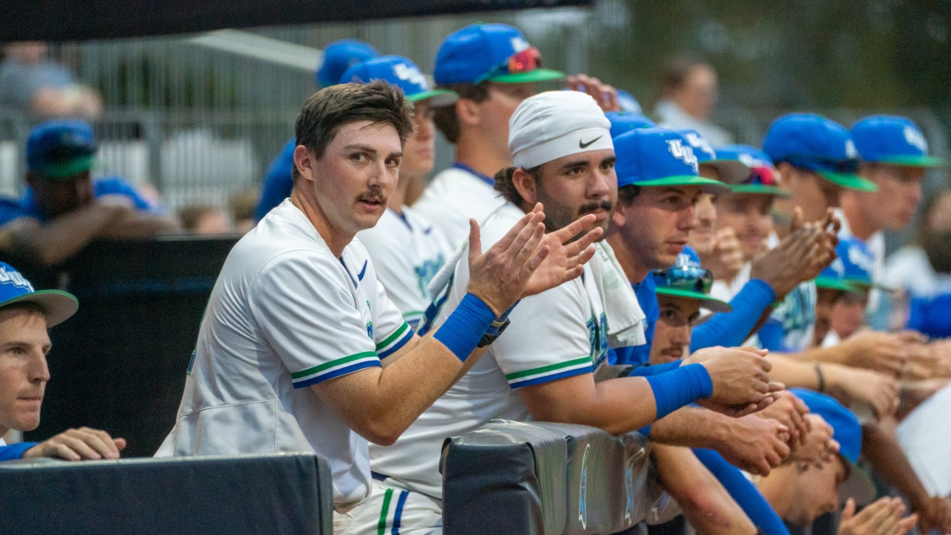 Team in dugout clapping