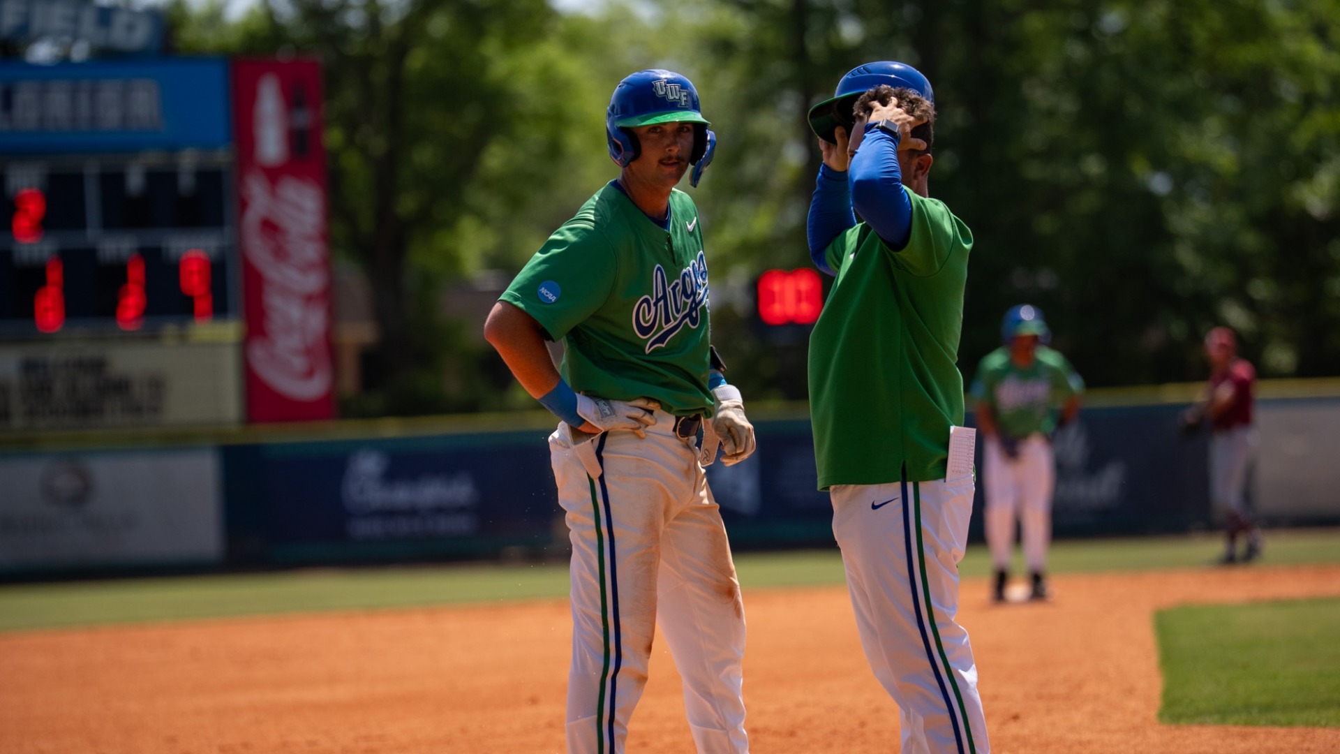 Tanner Taylor standing on third talking to Kyle Brown