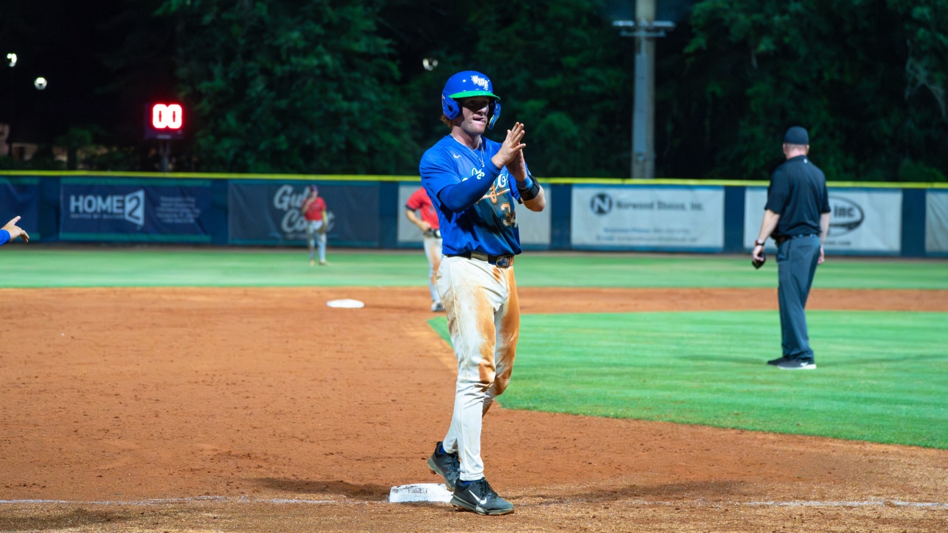 William Lybrook celebrates into the dugout on third base 