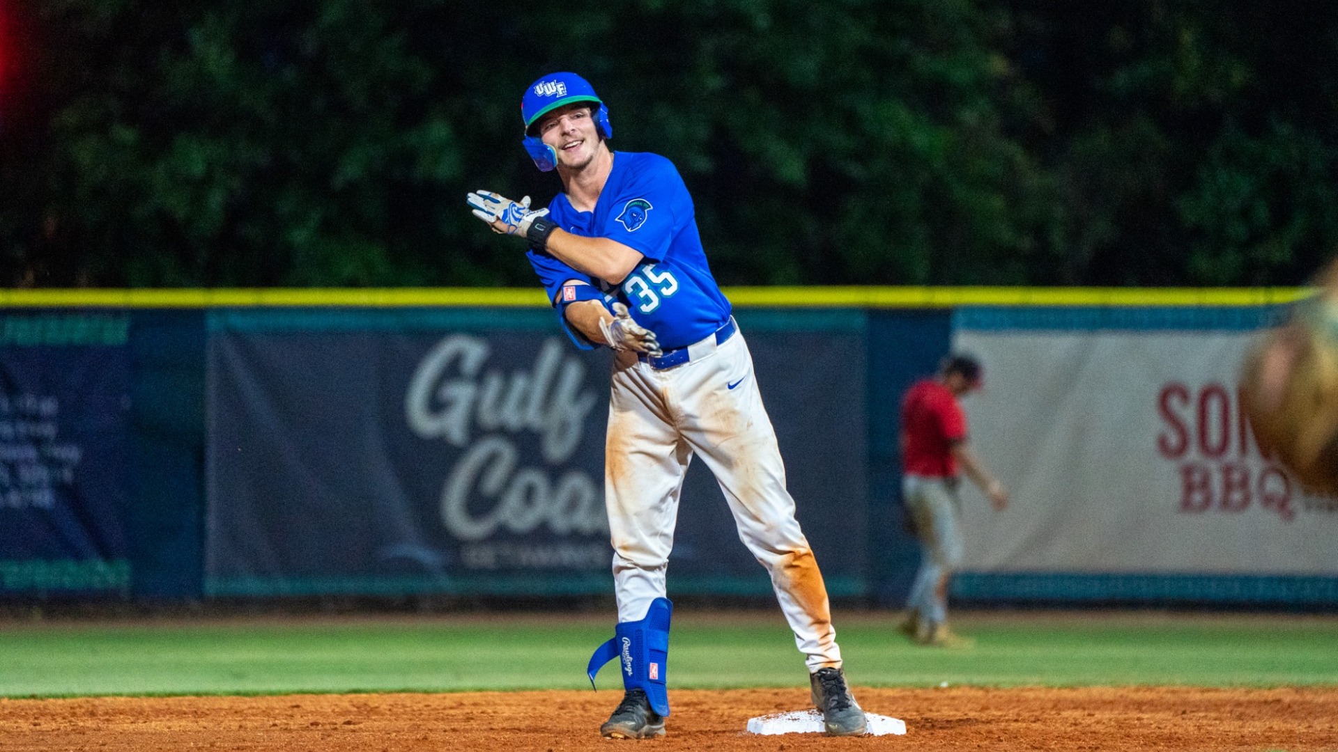 Ethan Babcock celebrates on second base after a double