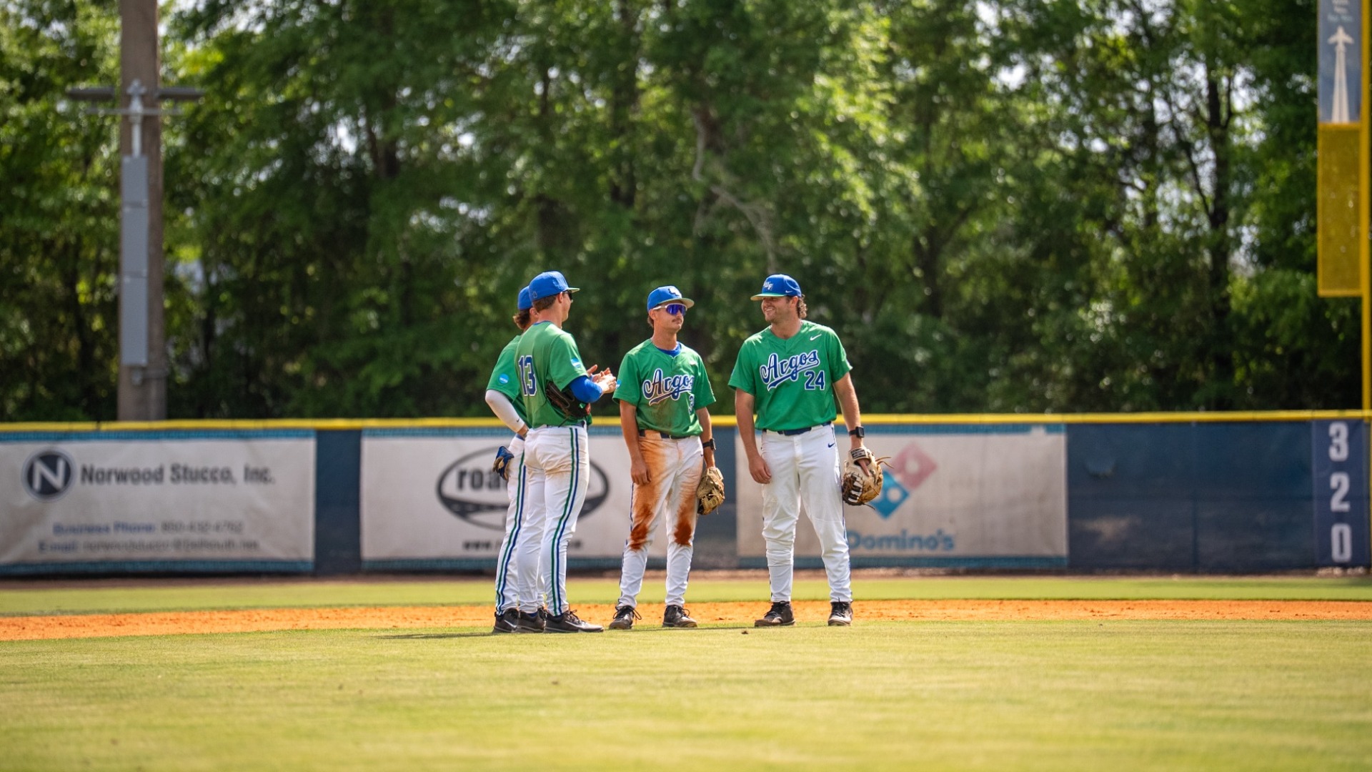 Infield players standing together talking