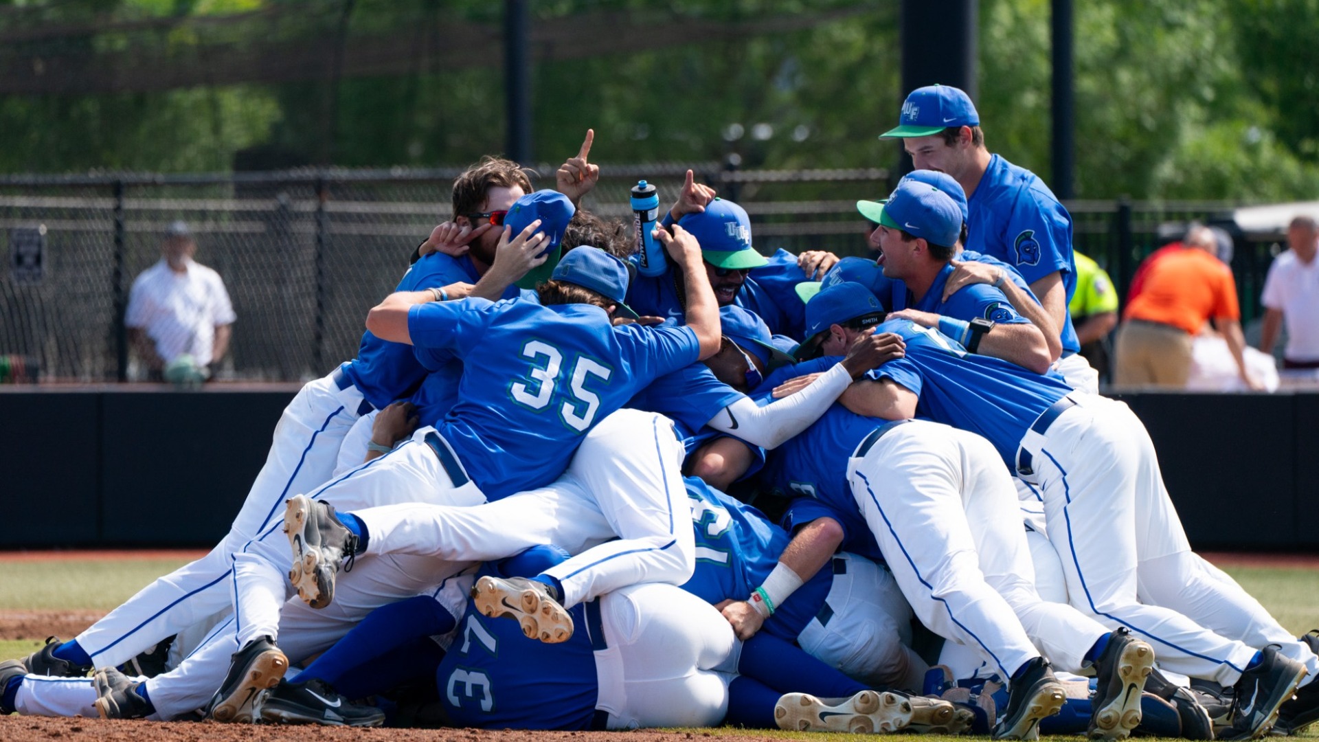 Baseball dog pile after winning GSC Championship