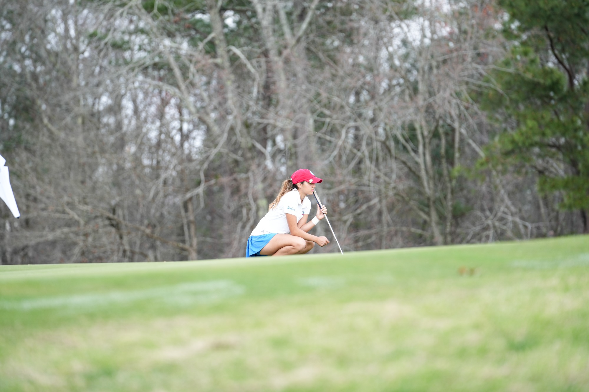 WGOLF at Chris Banister Golf Classic
UWG Female golfer watches ball while wearing white shirt with blue pants!