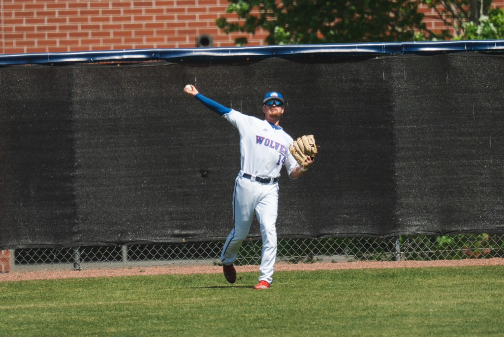 UWG baseball player in white throwing ball from the outfield 
