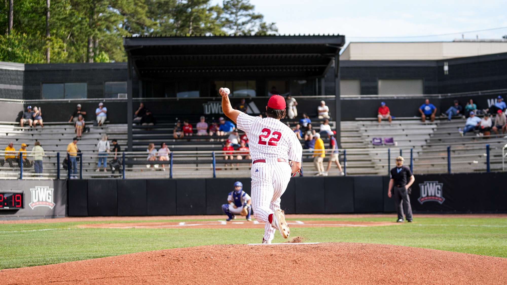 UWG baseball player in white pitching