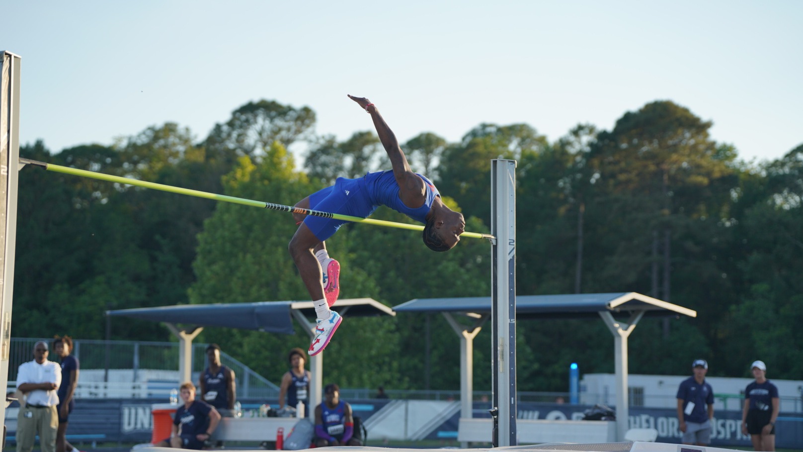 UWG’s Isaiah McMichael clears the bar during the high jump competition at the ASUN Outdoor Championships in Jacksonville, Florida. McMichael is captured midair above the bar as teammates and spectators watch from the infield.