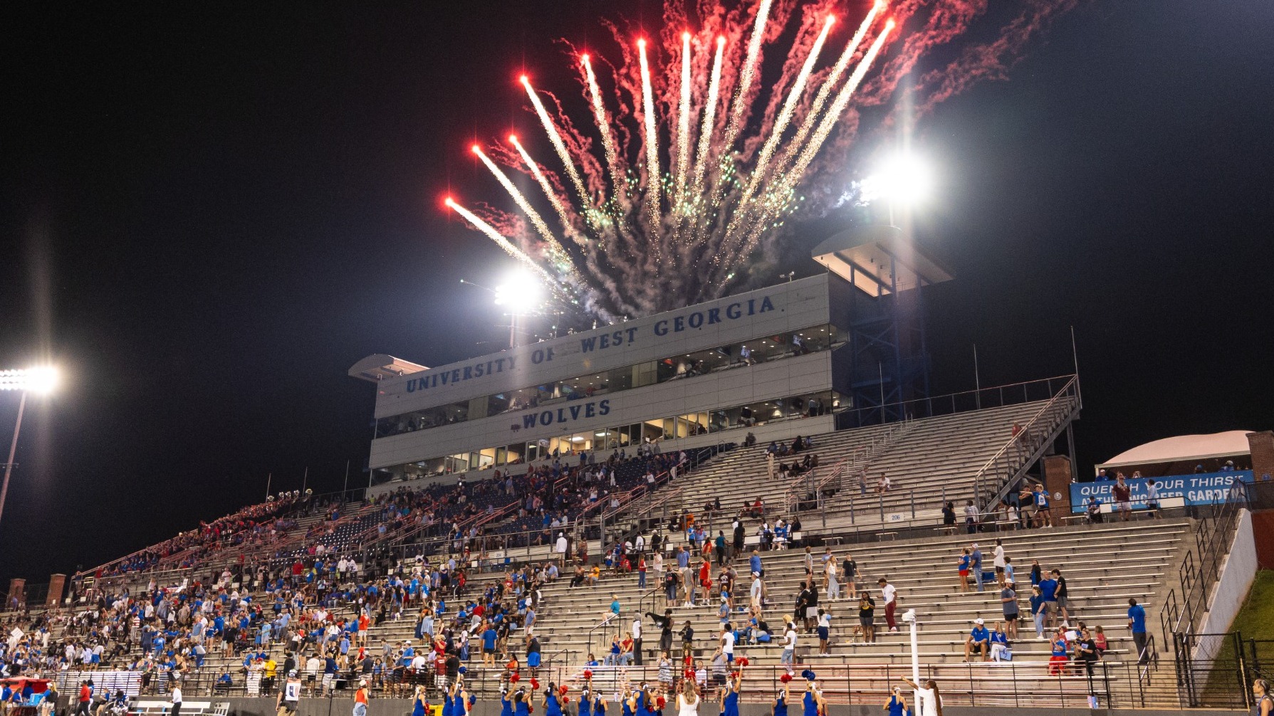 UWG football stadium. Red and white fireworks streaking through sky 