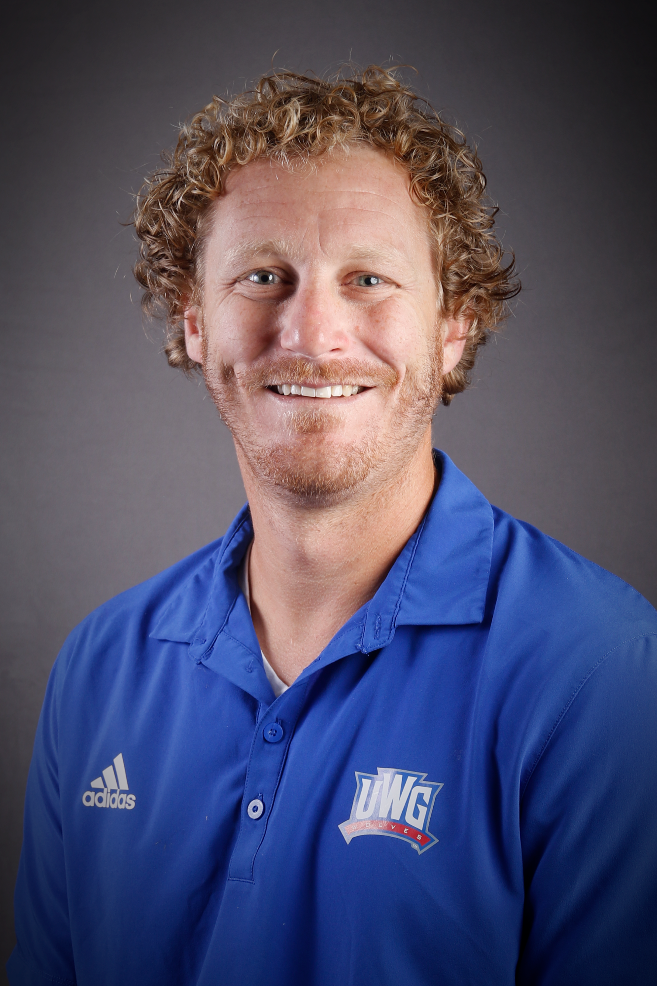 Headshot of Football coach in Blue Polo