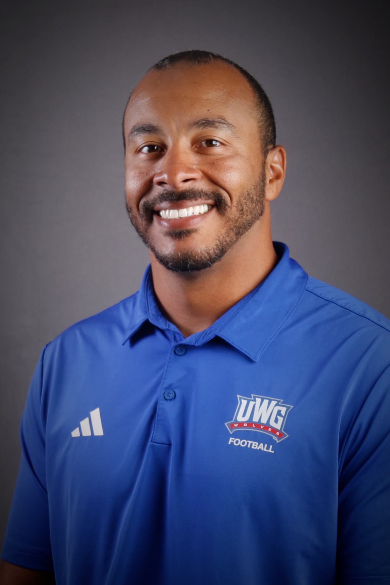 Headshot of Football coach in Blue Polo