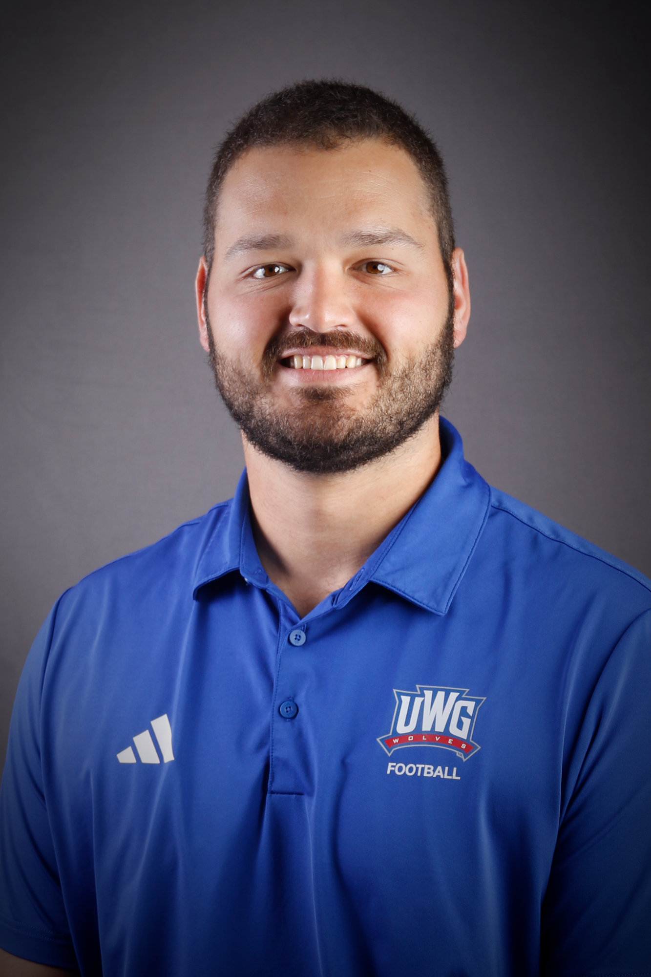 Headshot of Football coach in Blue Polo