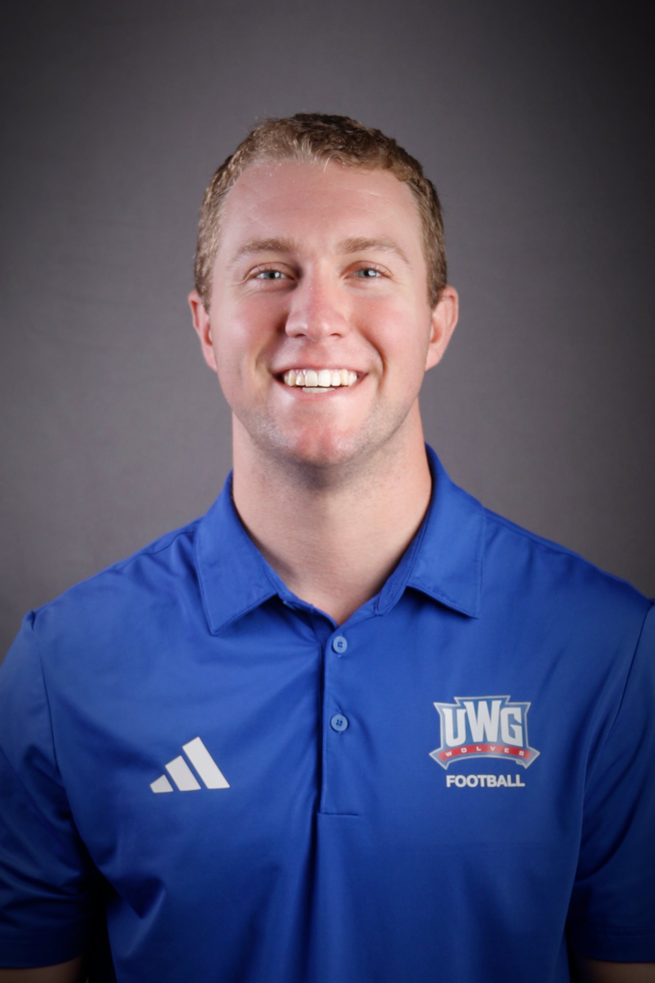 Headshot of Football coach in Blue Polo