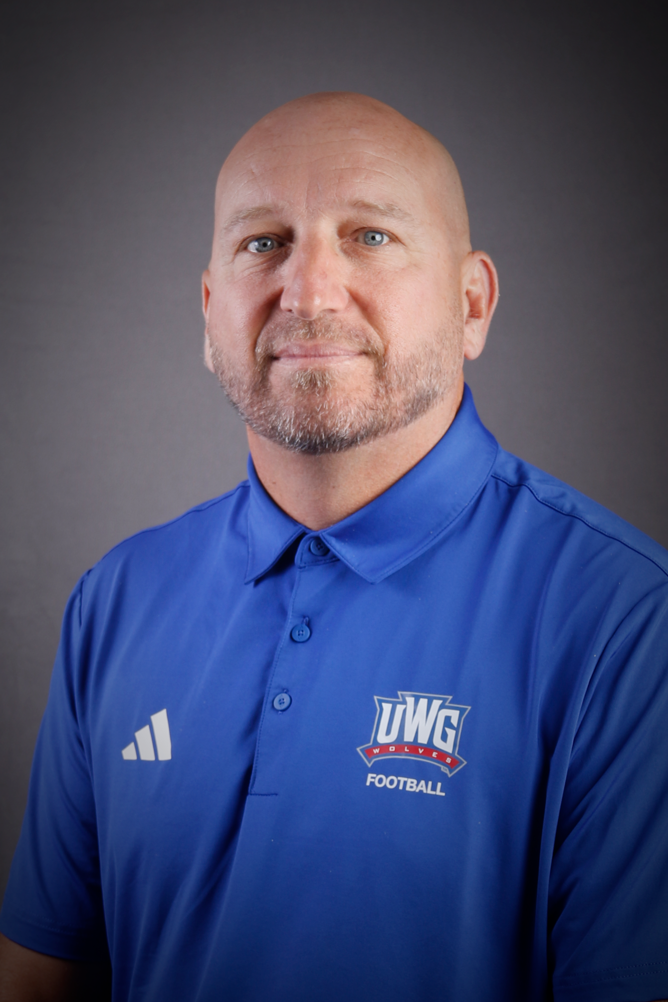 Headshot of Football coach in Blue Polo