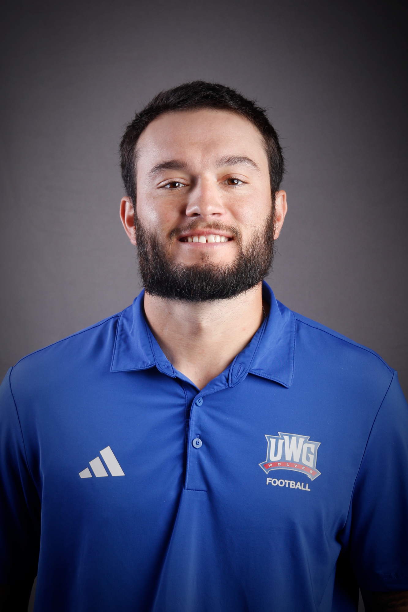 Headshot of Football coach in Blue Polo