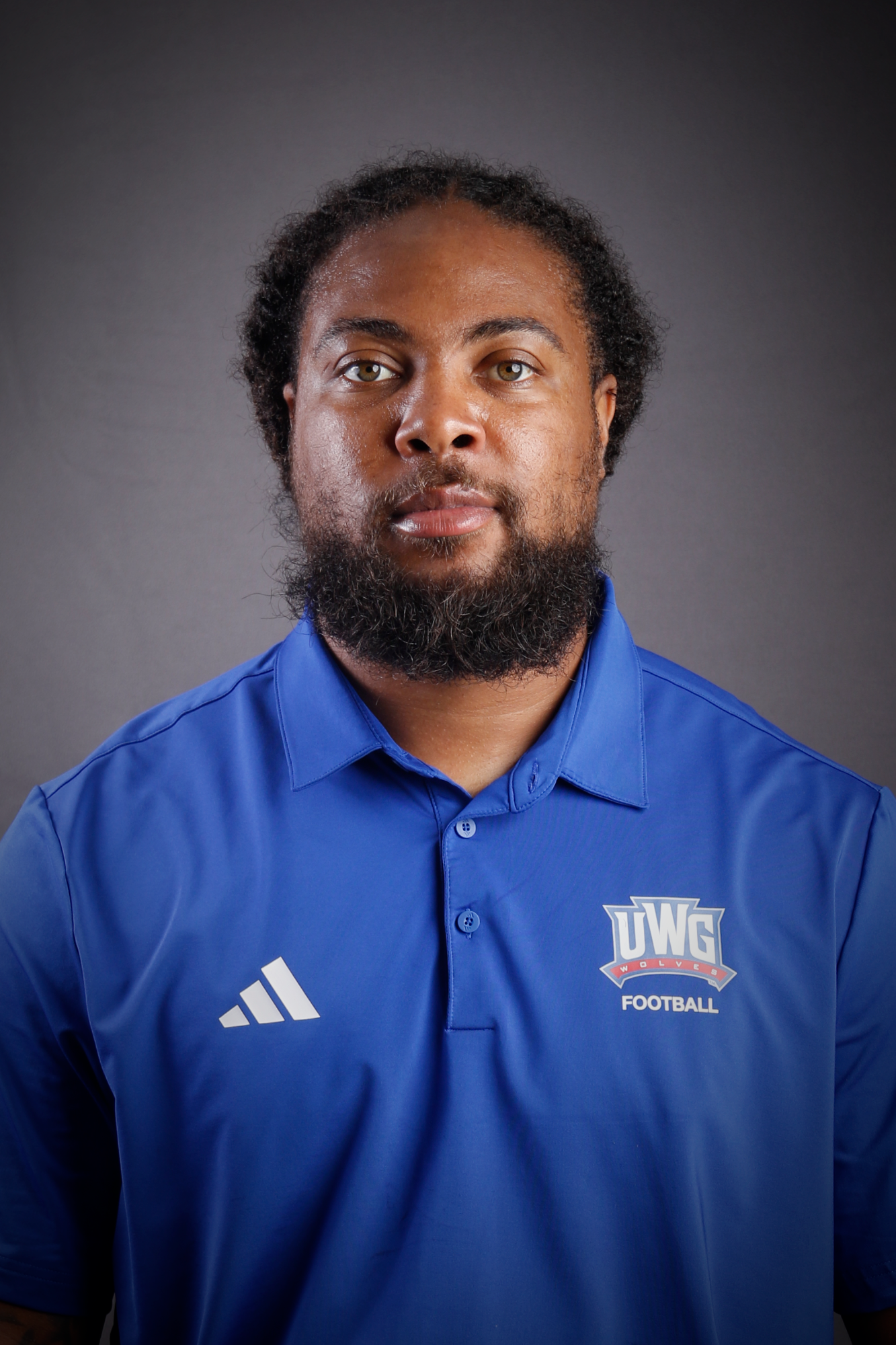Headshot of Football coach in Blue Polo